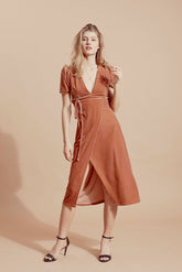 Velvet wrap midi dress with puff sleeves and deep V-neckline for elegant day-to-evening wear